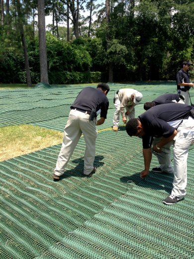 GrassProtecta grass reinforcement mesh being installed for temporary parking in Houston